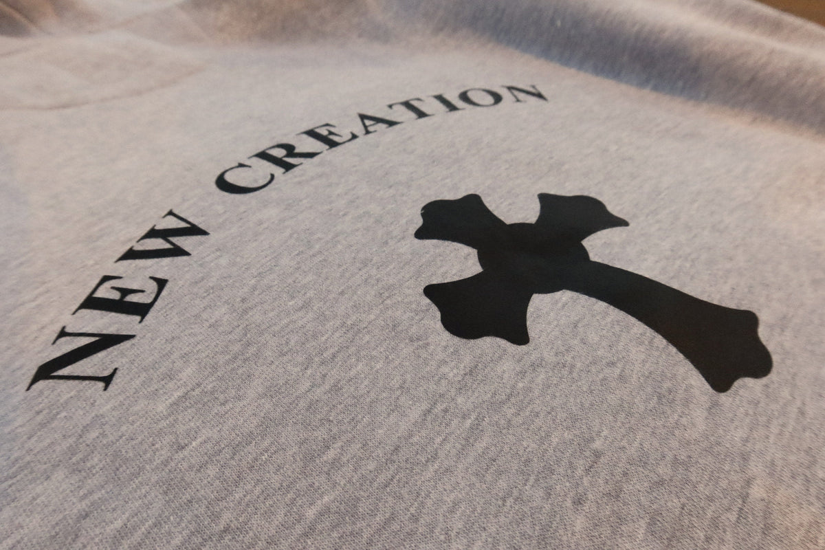 NEW CREATION cross on heather grey, close