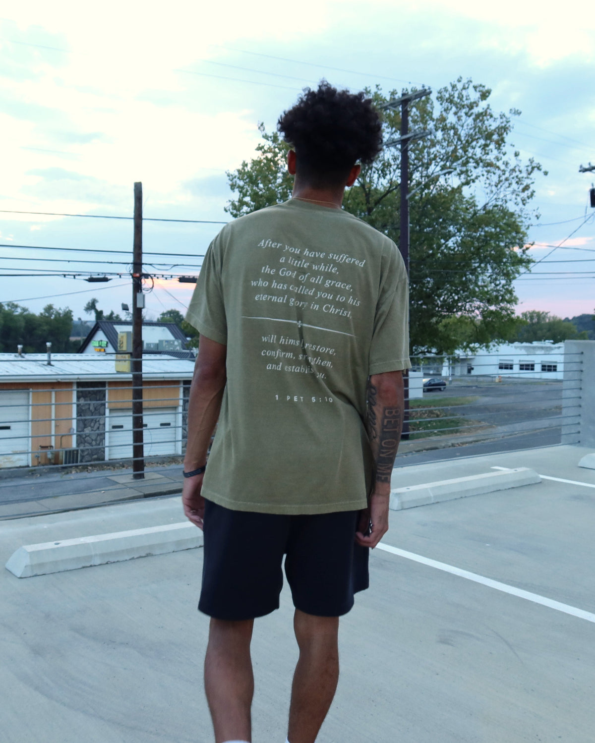 RESTORE tee worn, 1 Pet. 5:10 across the back
