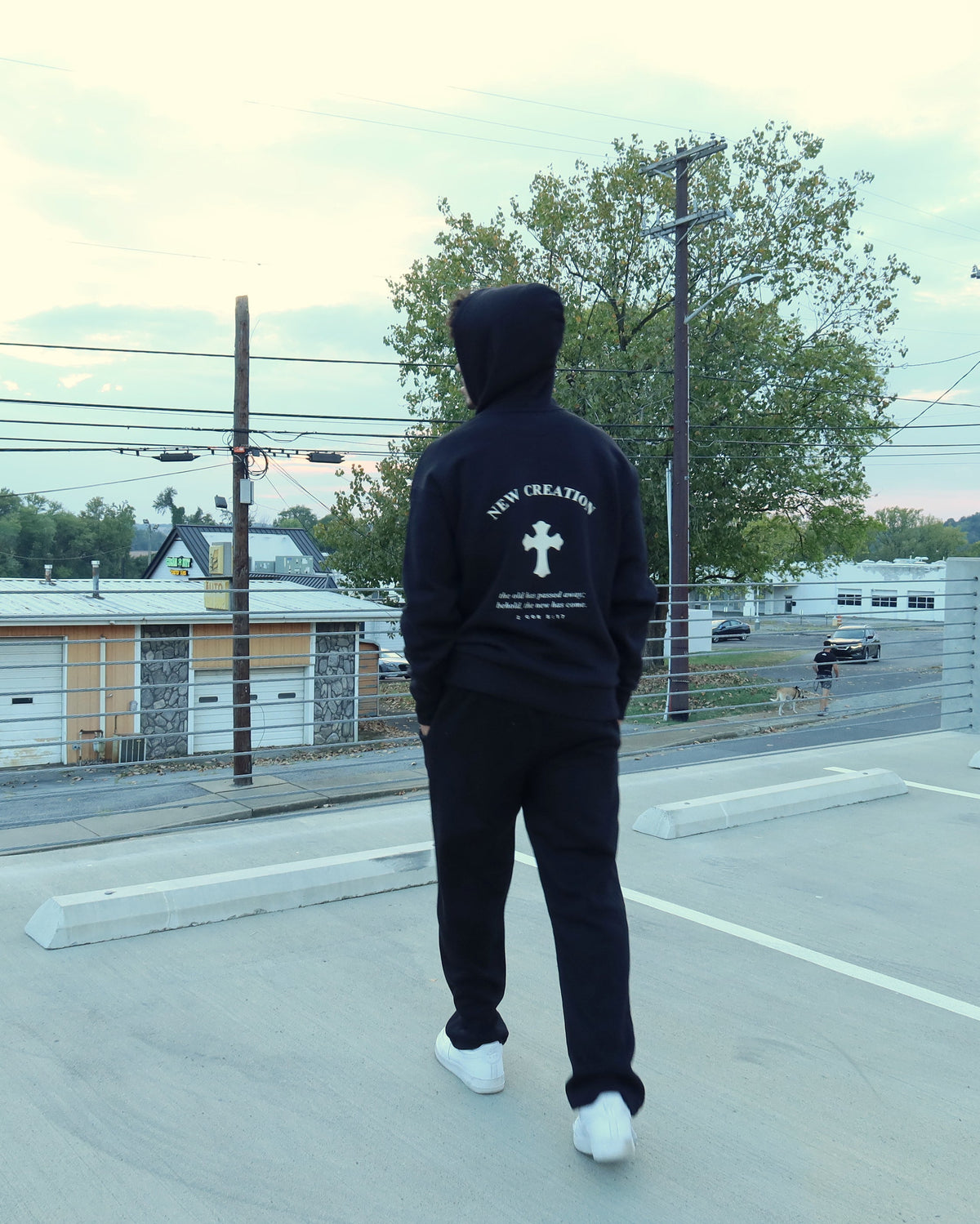 NEW CREATION hoodie in black, back print, walking