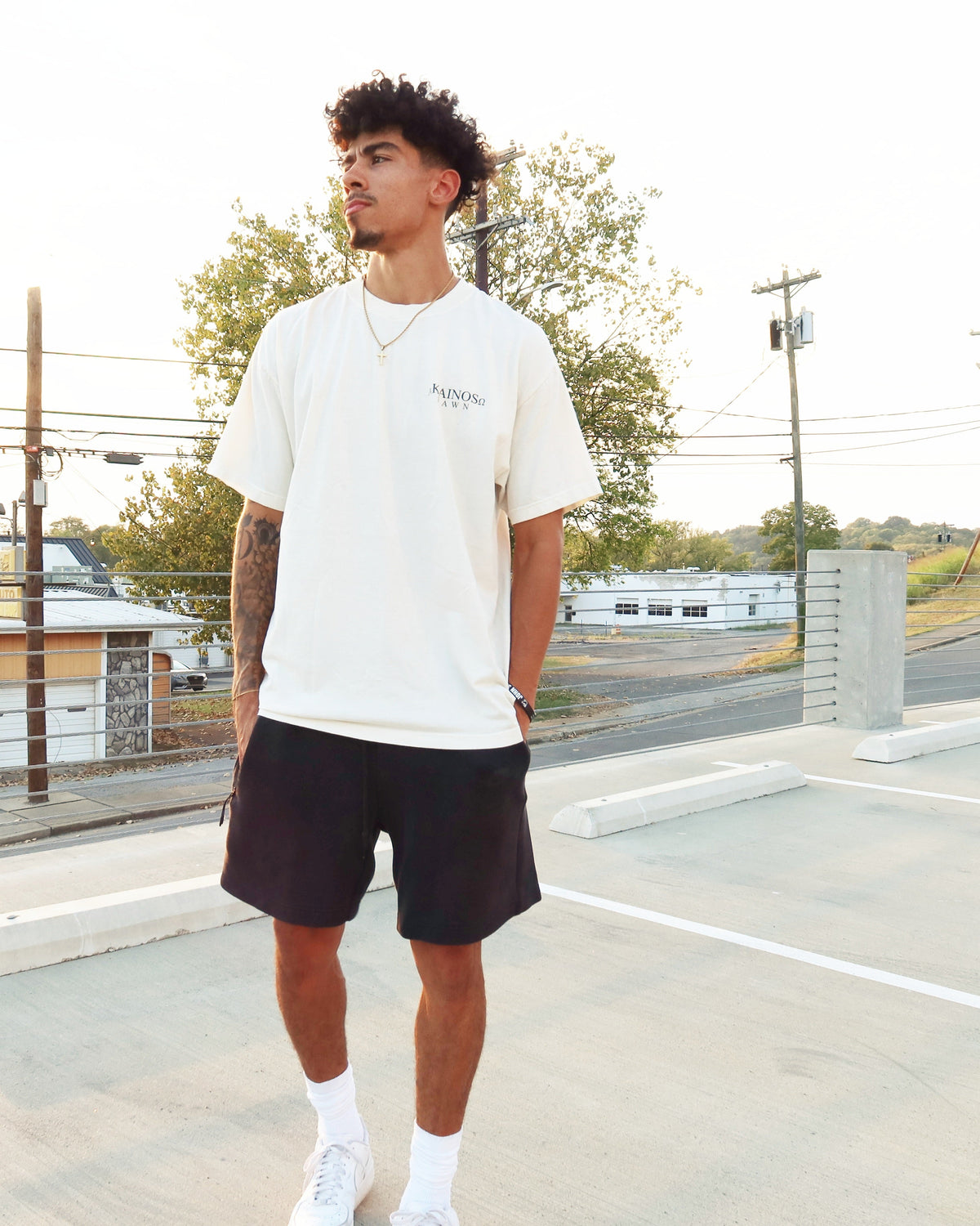 DAWN tee worn, front, with the KAINOS chest lockup