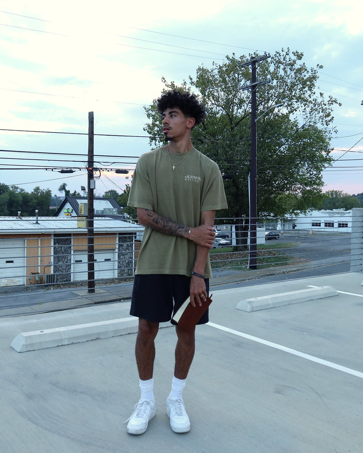 RESTORE tee worn, front, with the KAINOS chest lockup